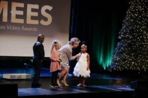 president angie presenting the award with 3 children