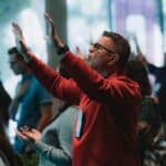 a man lifting his hands in worship