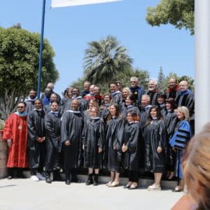 the group of masters students in gowns smiling