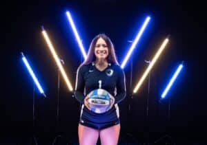 a volleyball player taking a photo in the digital media studio