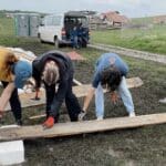 students working on the house