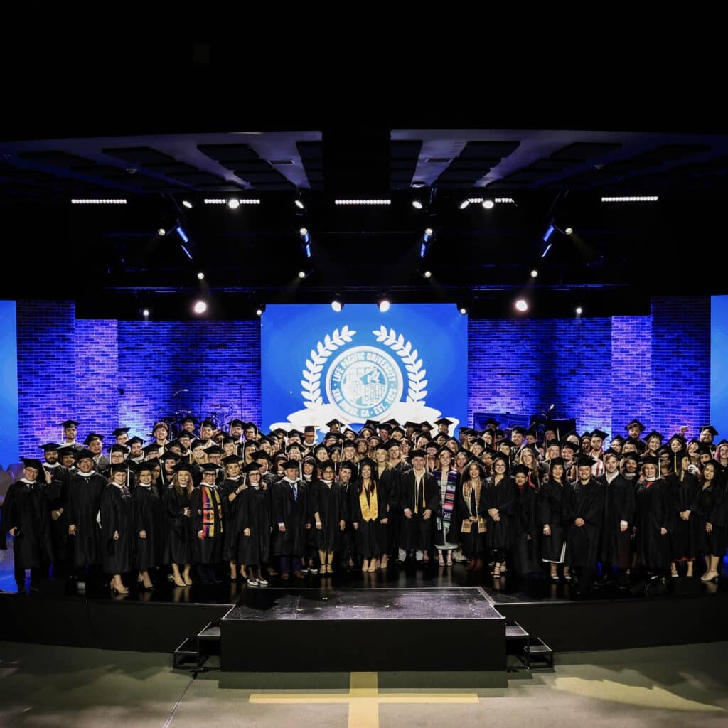 all lpu graduates standing on the commencement stage in their caps and gowns