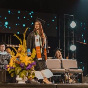 a female student walking across the stage