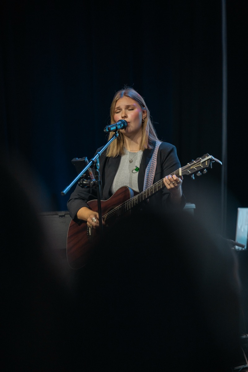LPU student leading worship with guitar and vocals