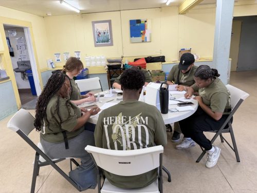 Filling out invitation cards to Anchor Church, where Noah and Rachele Coombs pastor